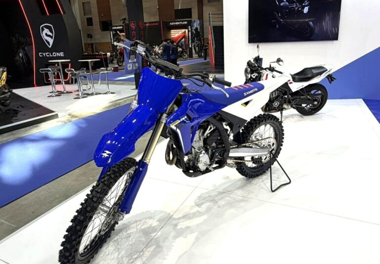 Moto tout-terrain ZXMOTO MX250 bleue et blanche exposée sur un salon